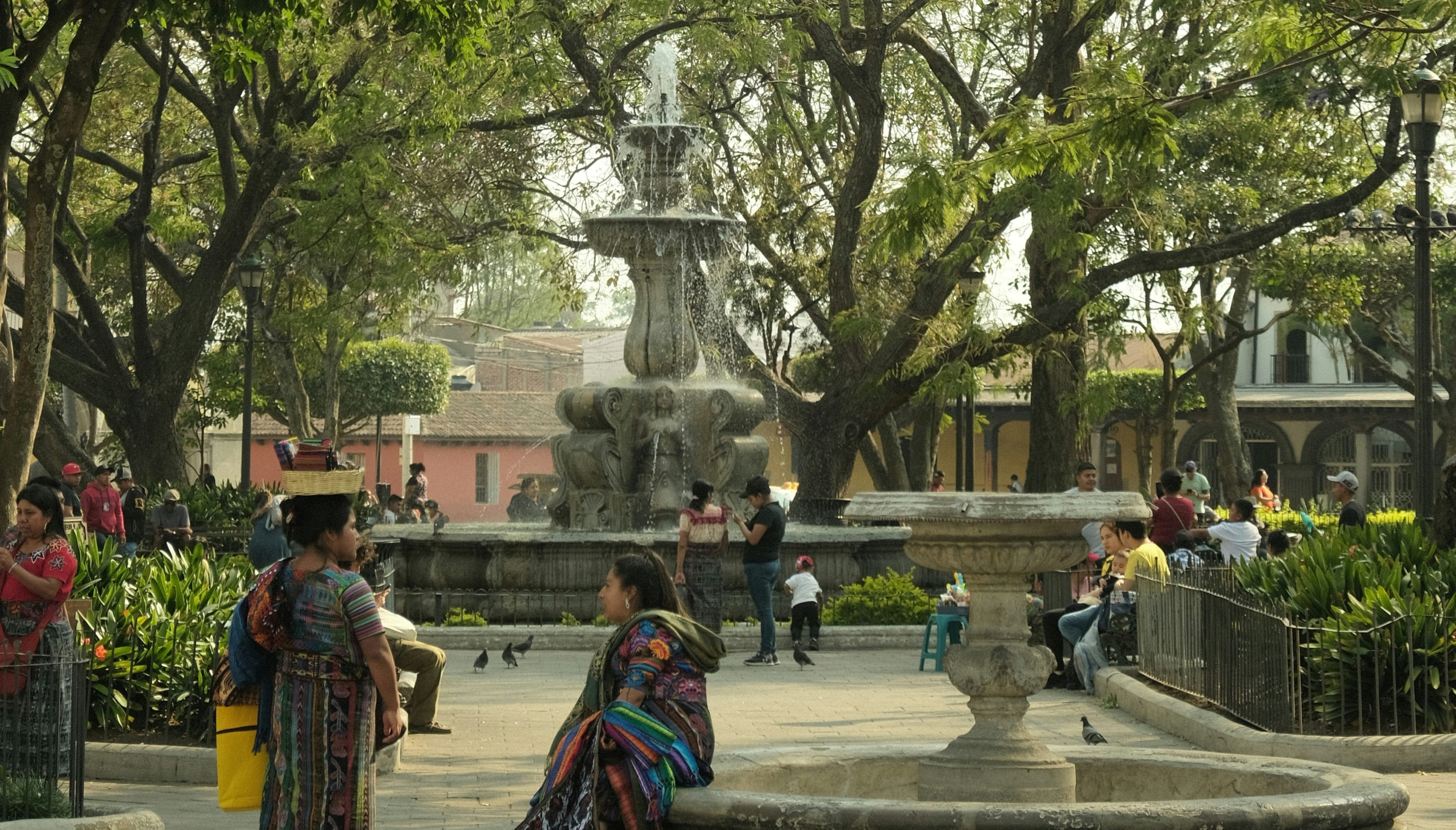 Colonial hotel courtyard with garden and wooden furniture near Parque Central in Antigua Guatemala